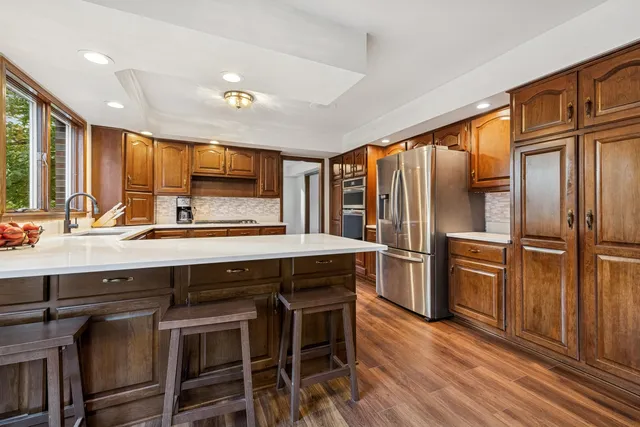 a dining room with furniture and wooden floor