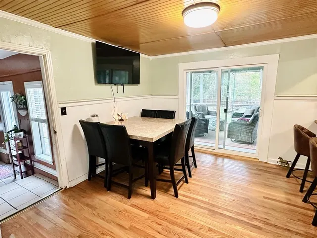 a dining room with furniture and wooden floor