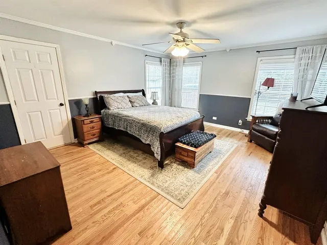 a living room with a bed furniture and a kitchen view