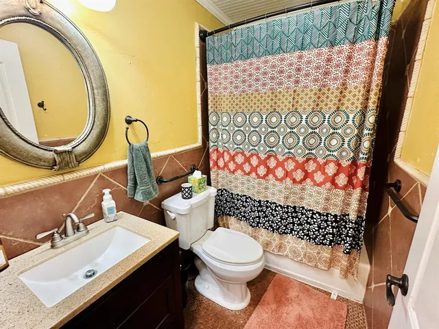 a bathroom with a sink toilet and mirror