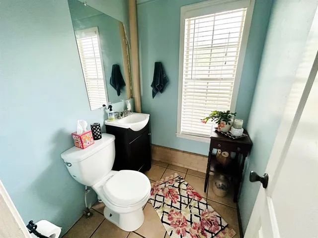 a bathroom with a sink toilet and a mirror