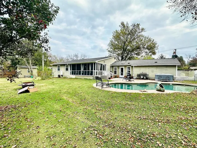 a view of a house with a swimming pool and sitting area