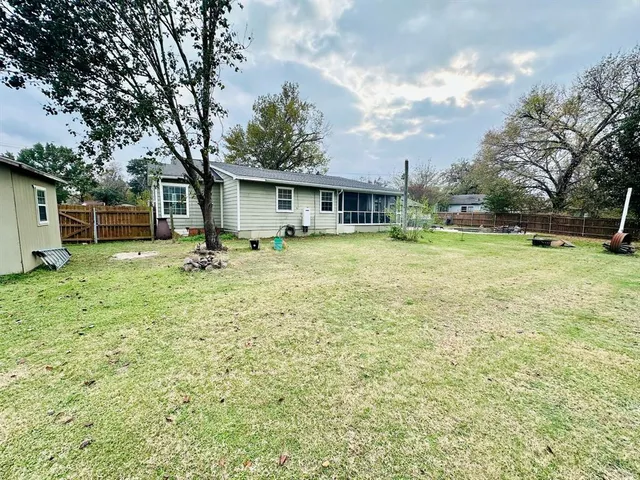 a backyard of a house with table and chairs