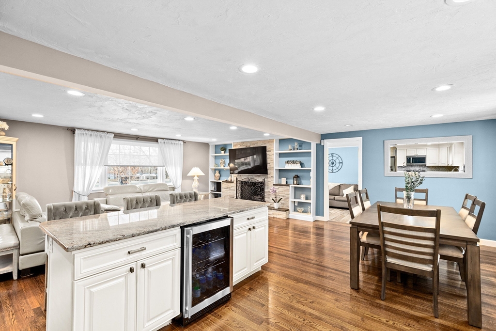 1368 Bay Road Stoughton, MA 02072 - Photo 13 of 42 a kitchen with a stove a sink a dining table and chairs