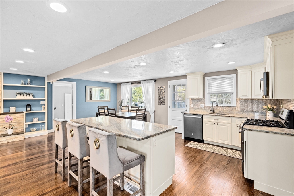 1368 Bay Road Stoughton, MA 02072 - Photo 14 of 42 a large kitchen with cabinets table and chairs
