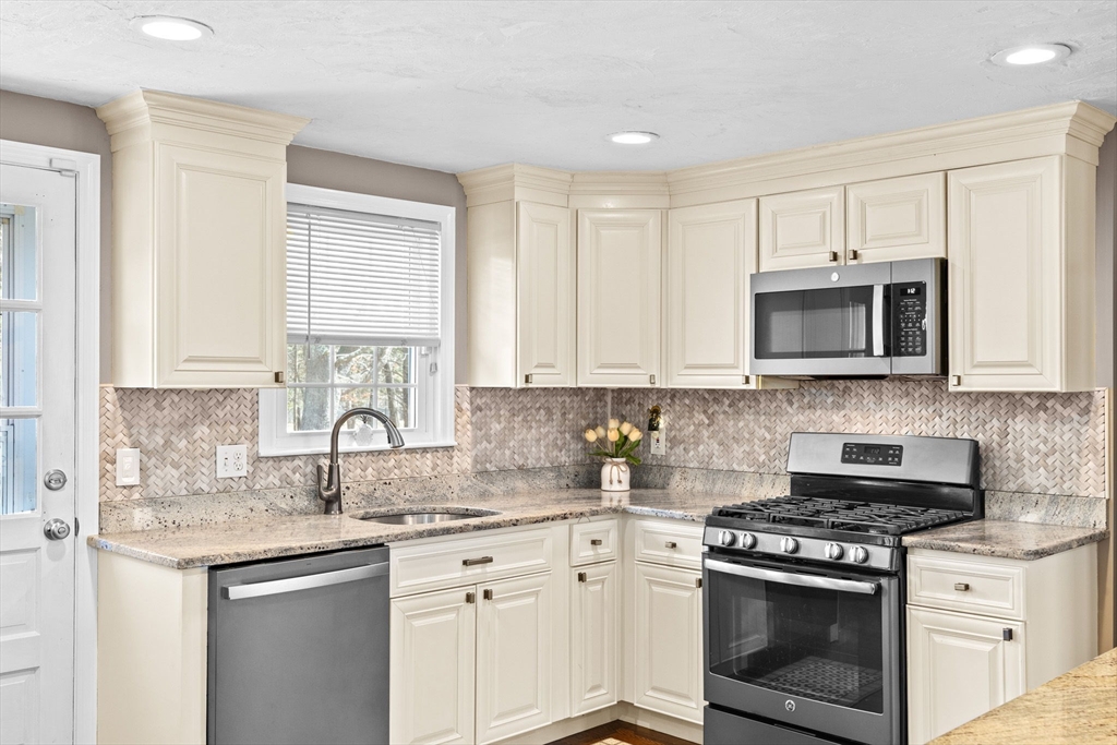 1368 Bay Road Stoughton, MA 02072 - Photo 16 of 42 a kitchen with sink a microwave and cabinets