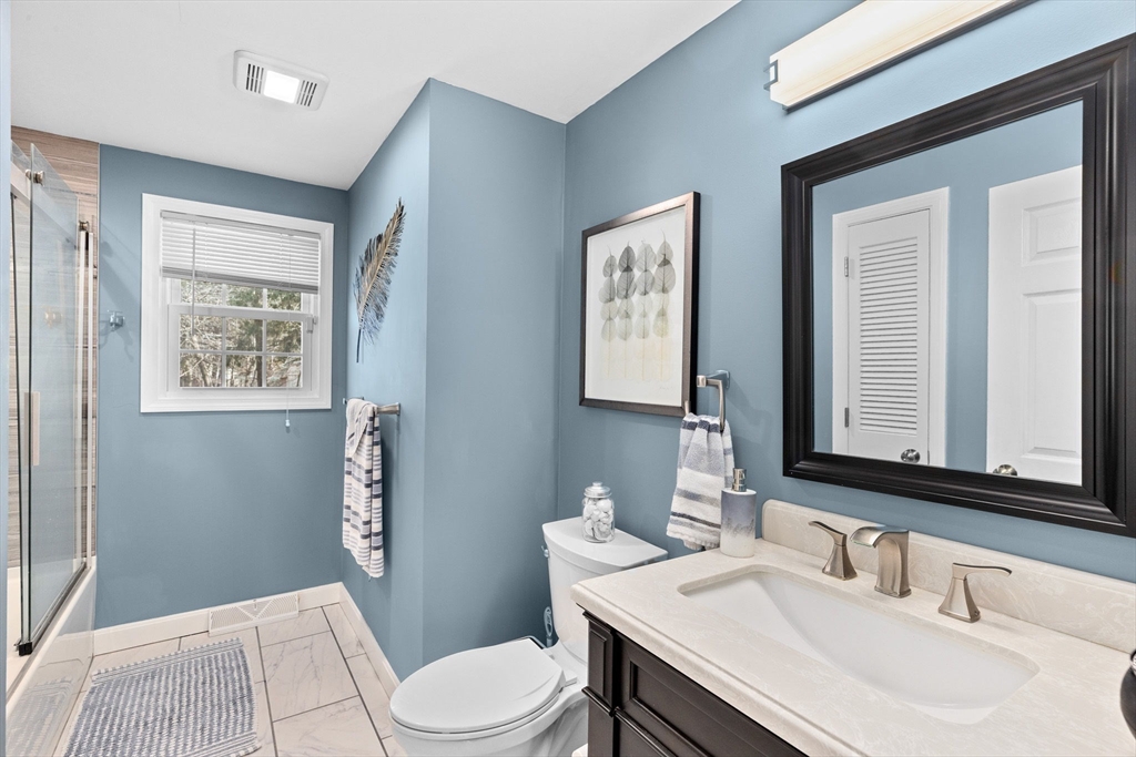 1368 Bay Road Stoughton, MA 02072 - Photo 21 of 42 a bathroom with a toilet a sink and a mirror