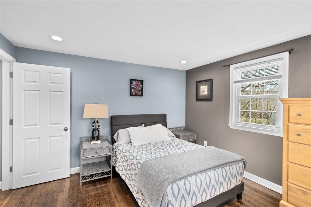 1368 Bay Road Stoughton, MA 02072 - Photo 24 of 42 a bedroom with a bed and a lamp on table