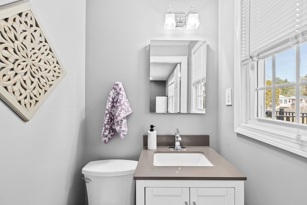 1368 Bay Road Stoughton, MA 02072 - Photo 28 of 42 a bathroom with a toilet sink and mirror