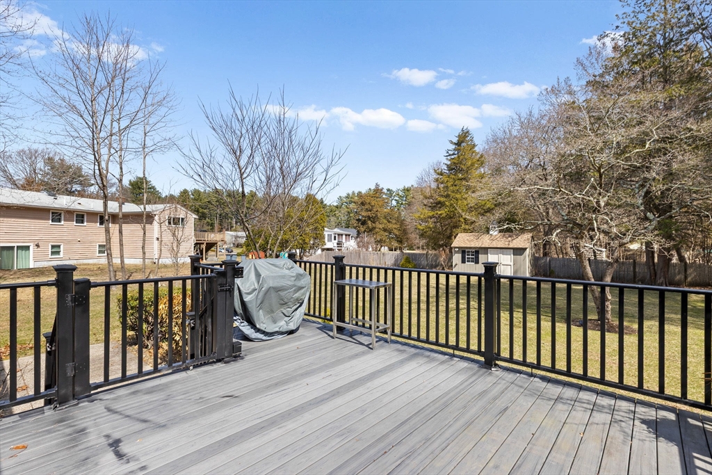 1368 Bay Road Stoughton, MA 02072 - Photo 29 of 42 a balcony with wooden floor and fence