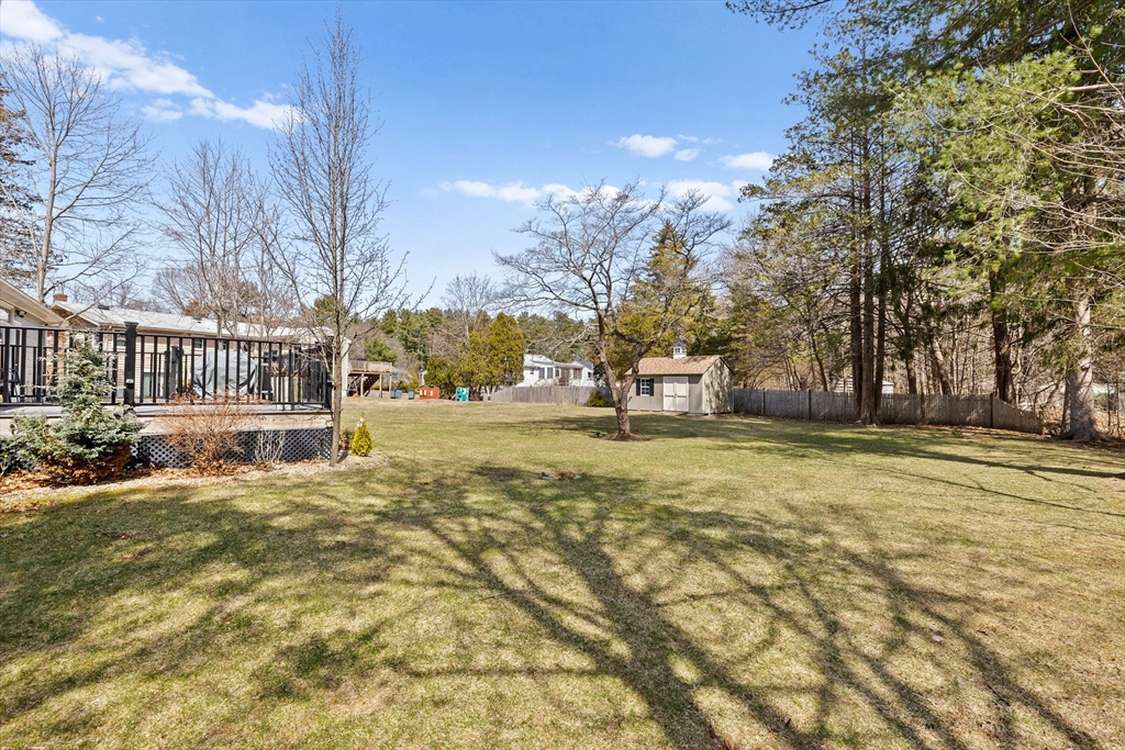 1368 Bay Road Stoughton, MA 02072 - Photo 37 of 42 a view of a yard with a house in the background