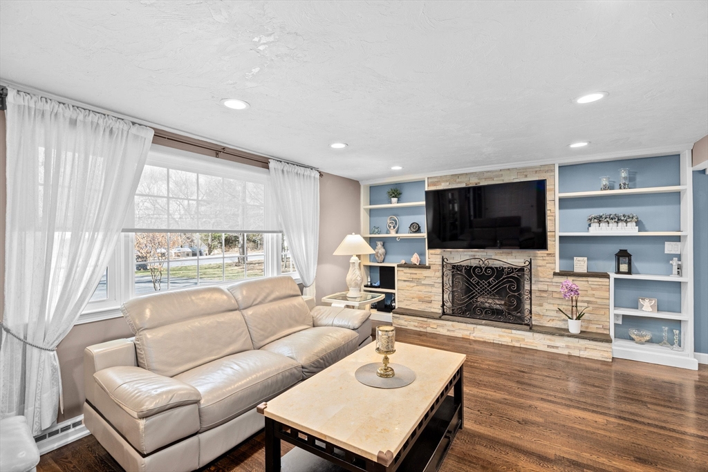 1368 Bay Road Stoughton, MA 02072 - Photo 5 of 42 a living room with fireplace furniture and a flat screen tv