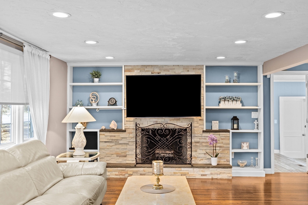 1368 Bay Road Stoughton, MA 02072 - Photo 6 of 42 a living room with furniture a fireplace and a flat screen tv