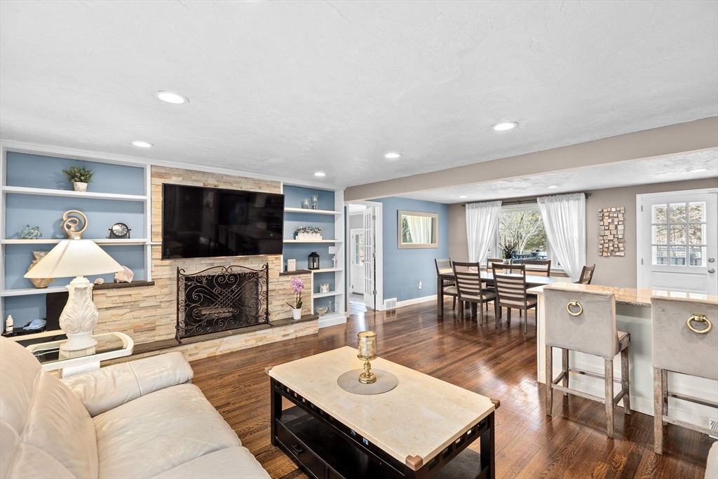 1368 Bay Road Stoughton, MA 02072 - Photo 7 of 42 a living room with furniture a flat screen tv and a fireplace