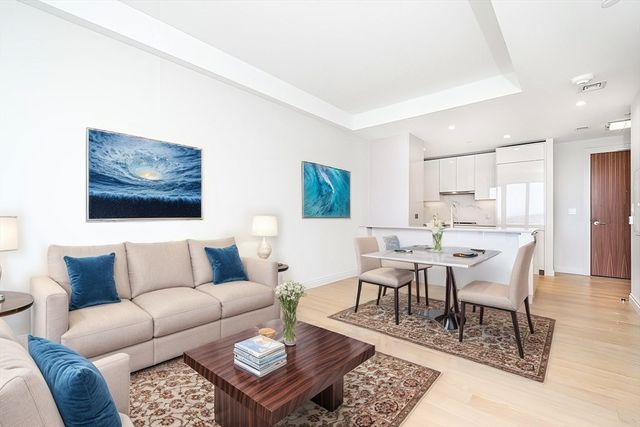 a living room with furniture a rug and a table