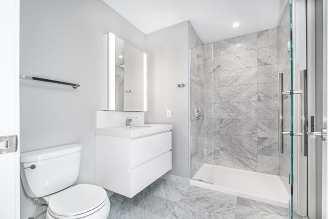 a bathroom with a sink toilet and shower