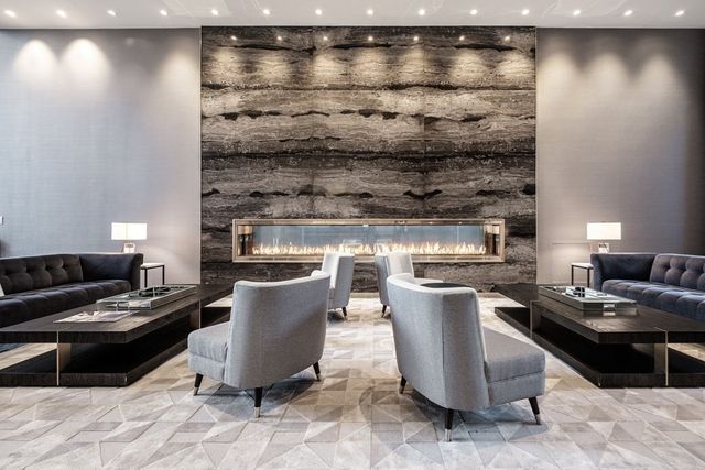 a living room with couches and kitchen view with wooden floor