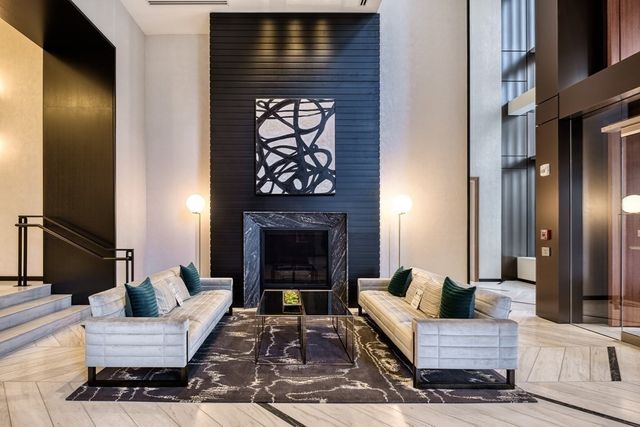 a living room with furniture large window and fireplace