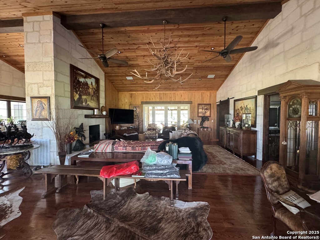 772 Luckenbach Road Fredericksburg, TX 78624 - Photo 11 of 86 a living room with furniture a flat screen tv and a fireplace