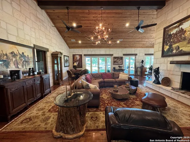 a living room with fireplace furniture and a wooden floor