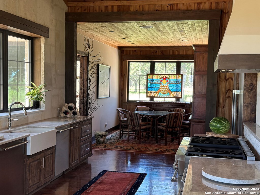 772 Luckenbach Road Fredericksburg, TX 78624 - Photo 25 of 86 a kitchen with stainless steel appliances granite countertop a stove a sink and a dining table