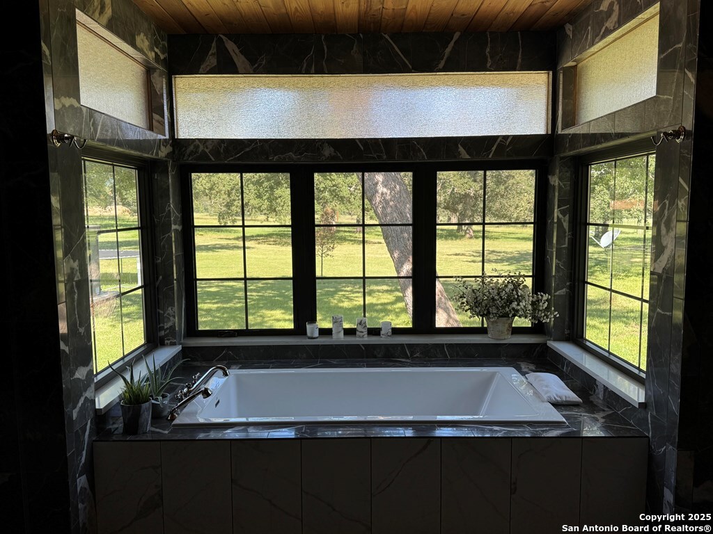 772 Luckenbach Road Fredericksburg, TX 78624 - Photo 33 of 86 a view of bathroom with tub and windows