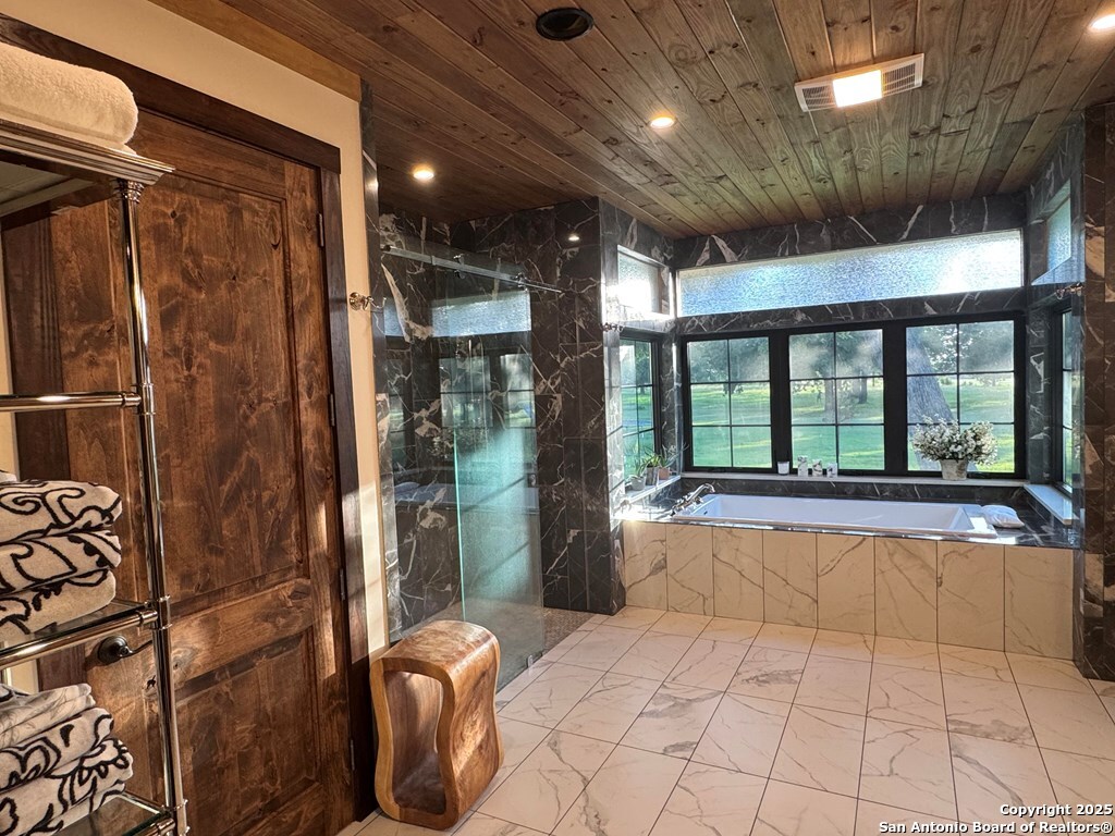 772 Luckenbach Road Fredericksburg, TX 78624 - Photo 34 of 86 a large bathroom with a tub and shower
