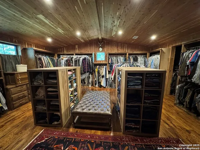 a bed room with furniture and a flat screen tv