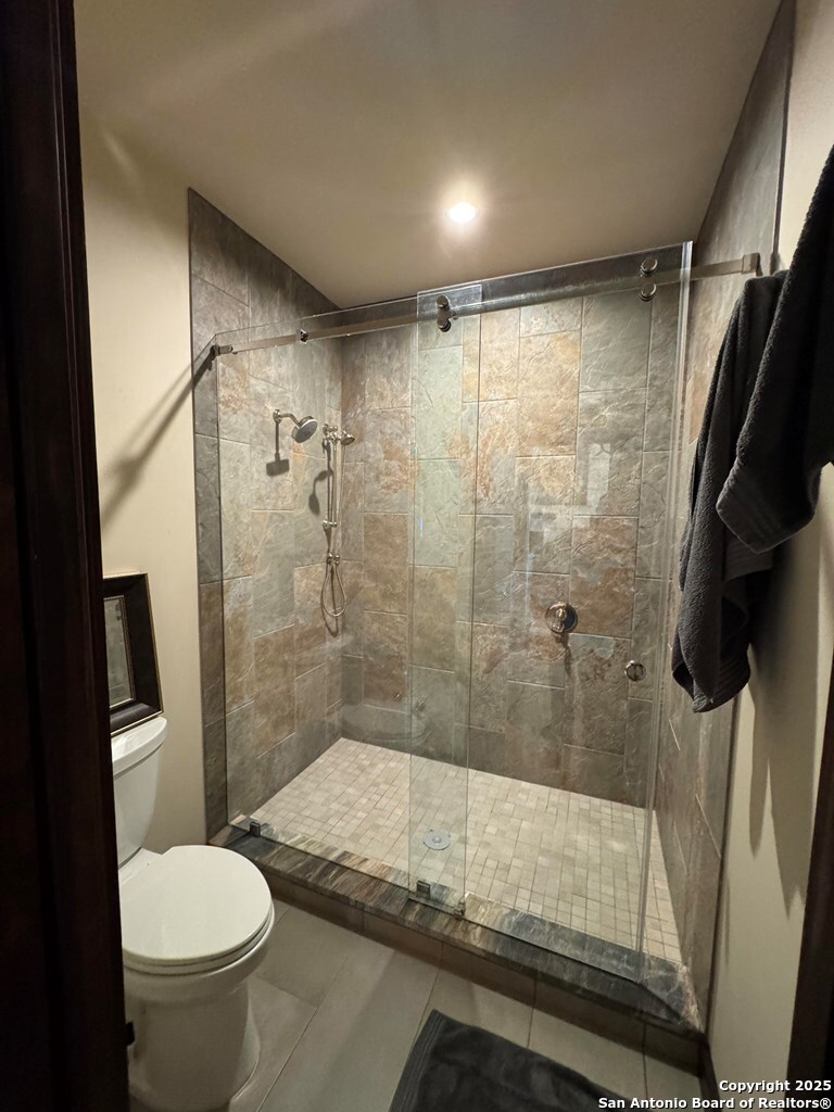 772 Luckenbach Road Fredericksburg, TX 78624 - Photo 41 of 86 a bathroom with a granite countertop sink toilet and shower