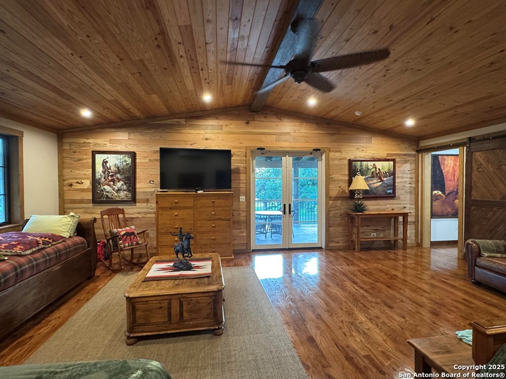 772 Luckenbach Road Fredericksburg, TX 78624 - Photo 49 of 86 a living room with furniture and a flat screen tv