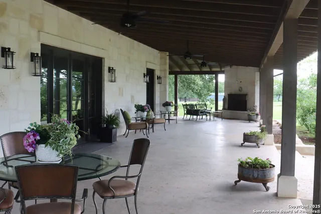 a view of a patio with table and chairs potted plants with wooden floor