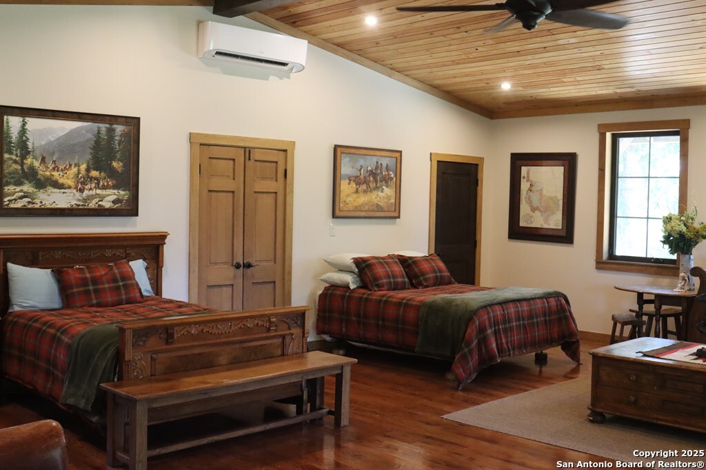 772 Luckenbach Road Fredericksburg, TX 78624 - Photo 52 of 86 a bedroom with a bed and wooden floor