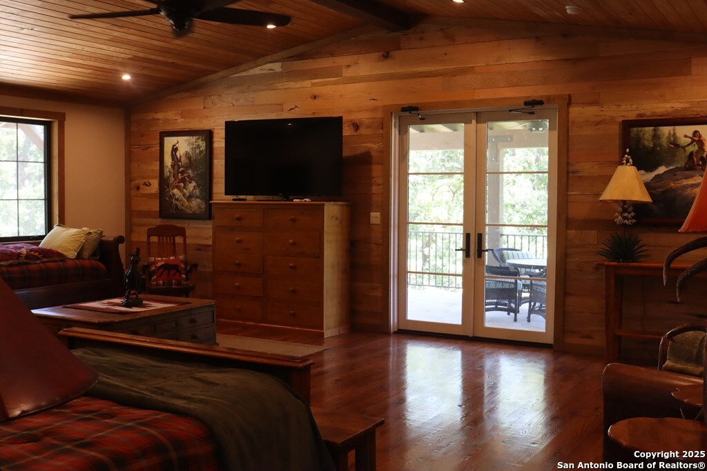 772 Luckenbach Road Fredericksburg, TX 78624 - Photo 54 of 86 a bed room with furniture and a flat screen tv