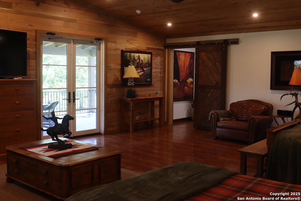 772 Luckenbach Road Fredericksburg, TX 78624 - Photo 55 of 86 a living room with furniture a flat screen tv and a window