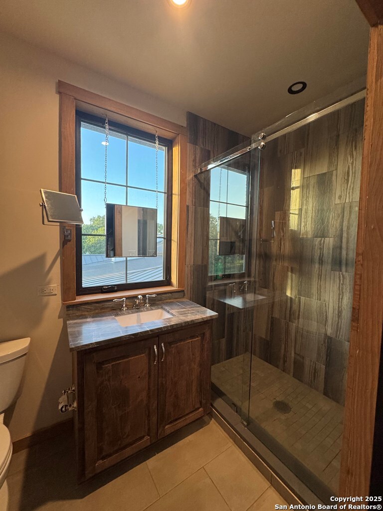 772 Luckenbach Road Fredericksburg, TX 78624 - Photo 57 of 86 a bathroom with a shower sink and mirror