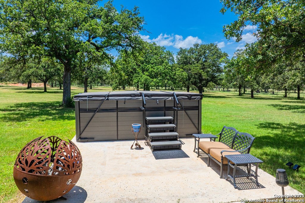 772 Luckenbach Road Fredericksburg, TX 78624 - Photo 62 of 86 a view of a backyard with wooden floor and a garden