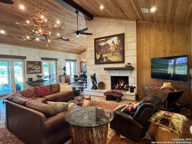 a living room with furniture a fireplace and a flat screen tv