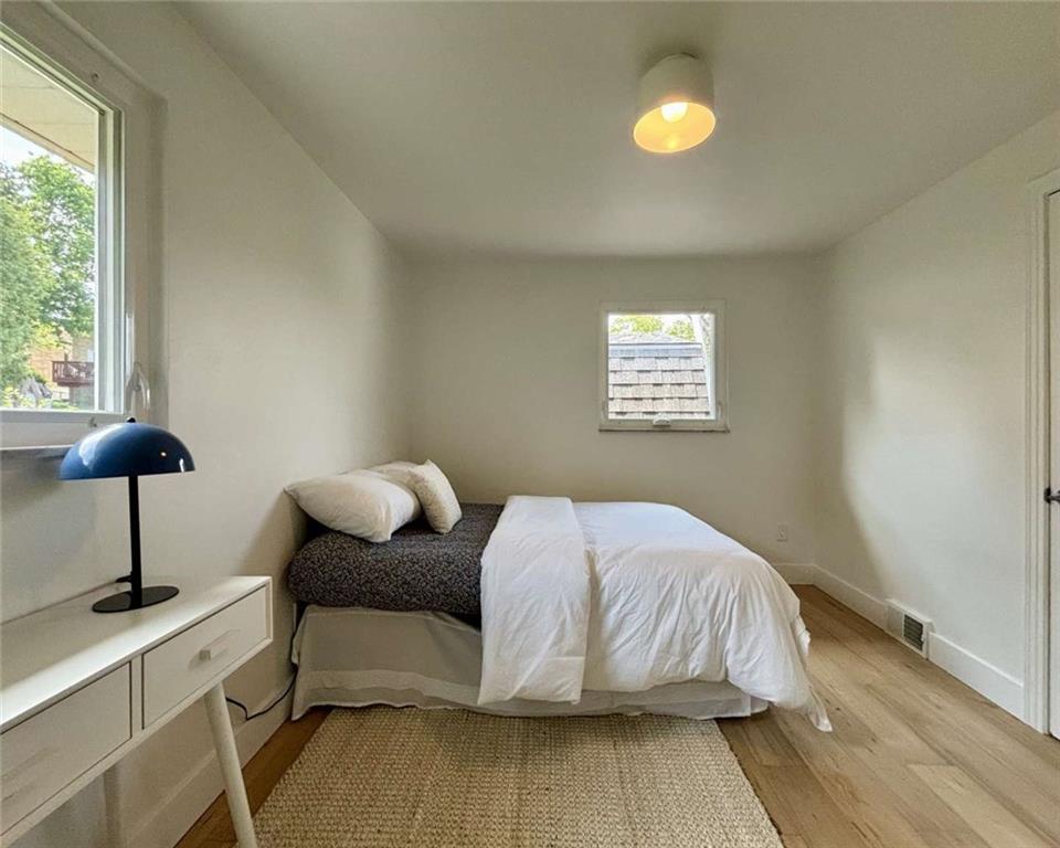4258 Glen Lytle Road Pittsburgh, PA 15217 - Photo 16 of 19 a bedroom with a bed and a lamp
