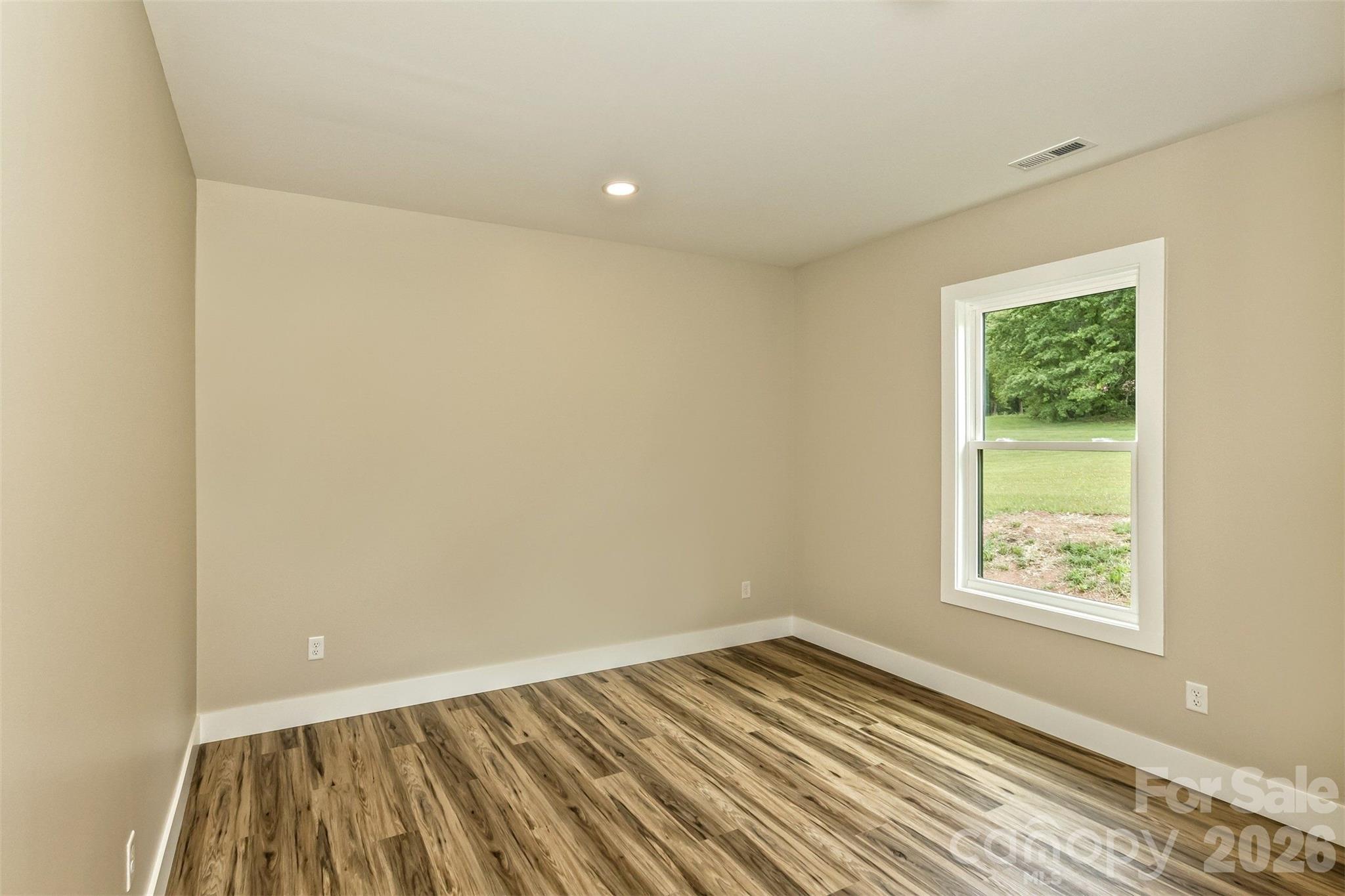 112 Peyton Elaine Road Clyde, NC 28721 - Photo 23 of 35 an empty room with wooden floor and windows