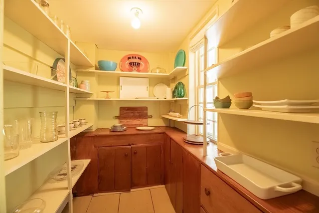 a bathroom with a sink a toilet and a window