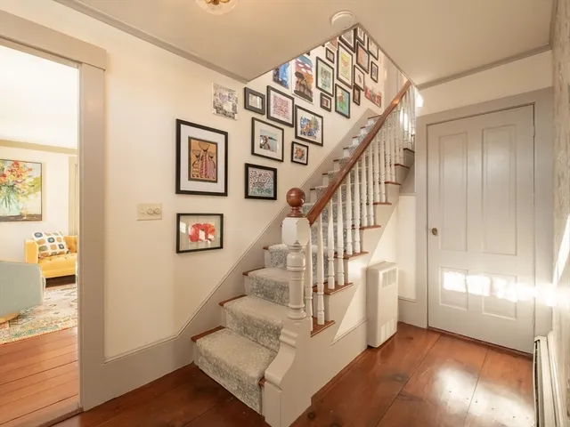 a very nice looking room with a large window and wooden floor