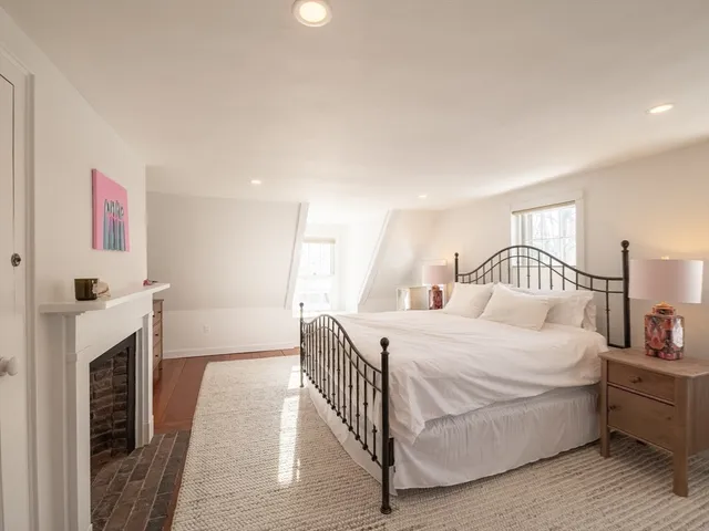 a bathroom with a tub shower sink and mirror