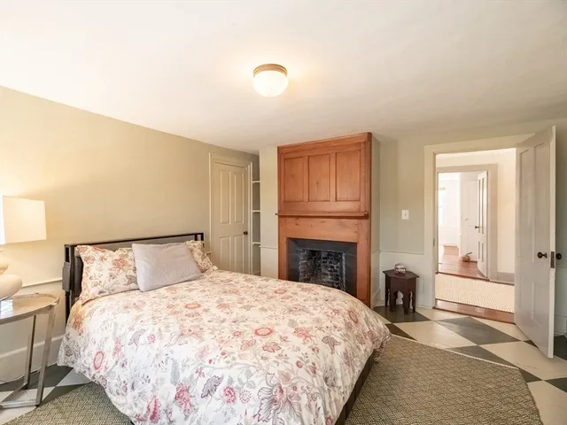 a bedroom with a bed a desk and chair