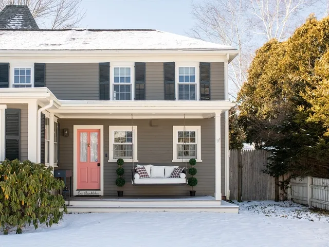 a kitchen with stainless steel appliances a dining table chairs refrigerator and sink