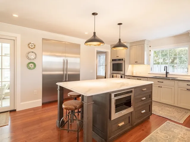 a kitchen with a stove a table and chairs in it