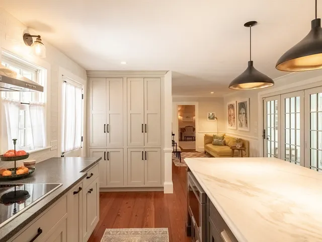 a living room with fireplace furniture and a wooden floor