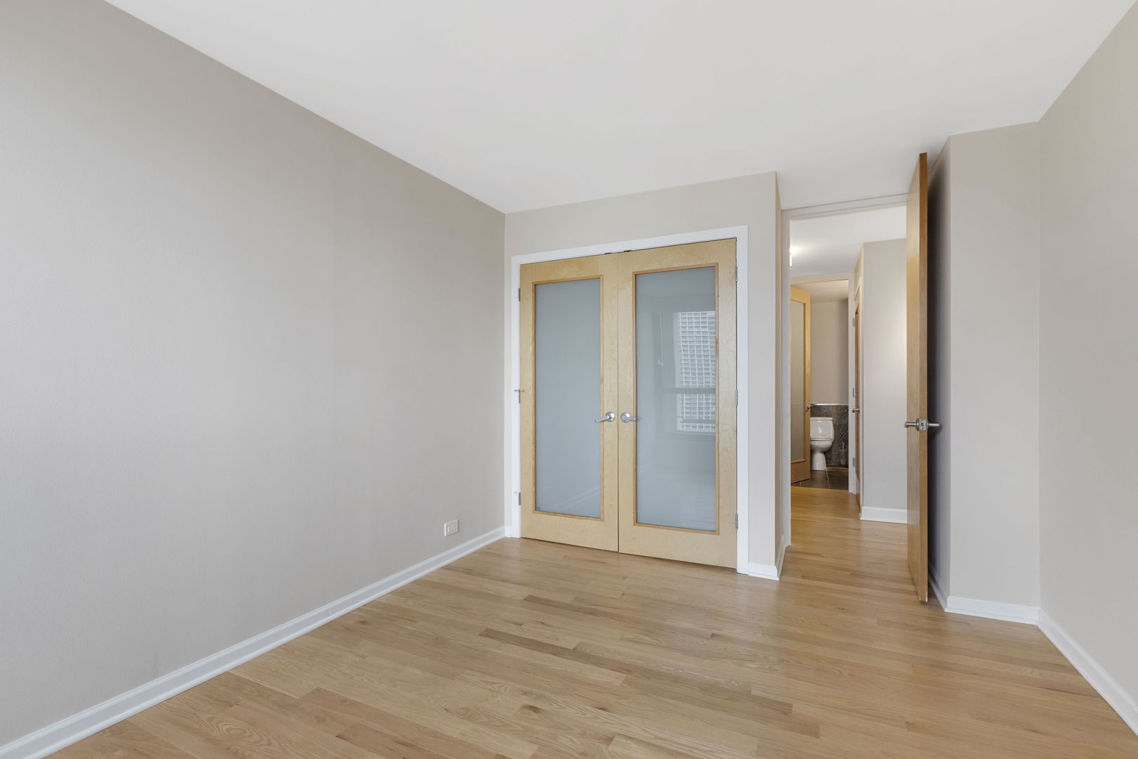 1030 North State Street, Unit 31E Chicago, IL 60610 - Photo 15 of 19 a view of an empty room with wooden floor