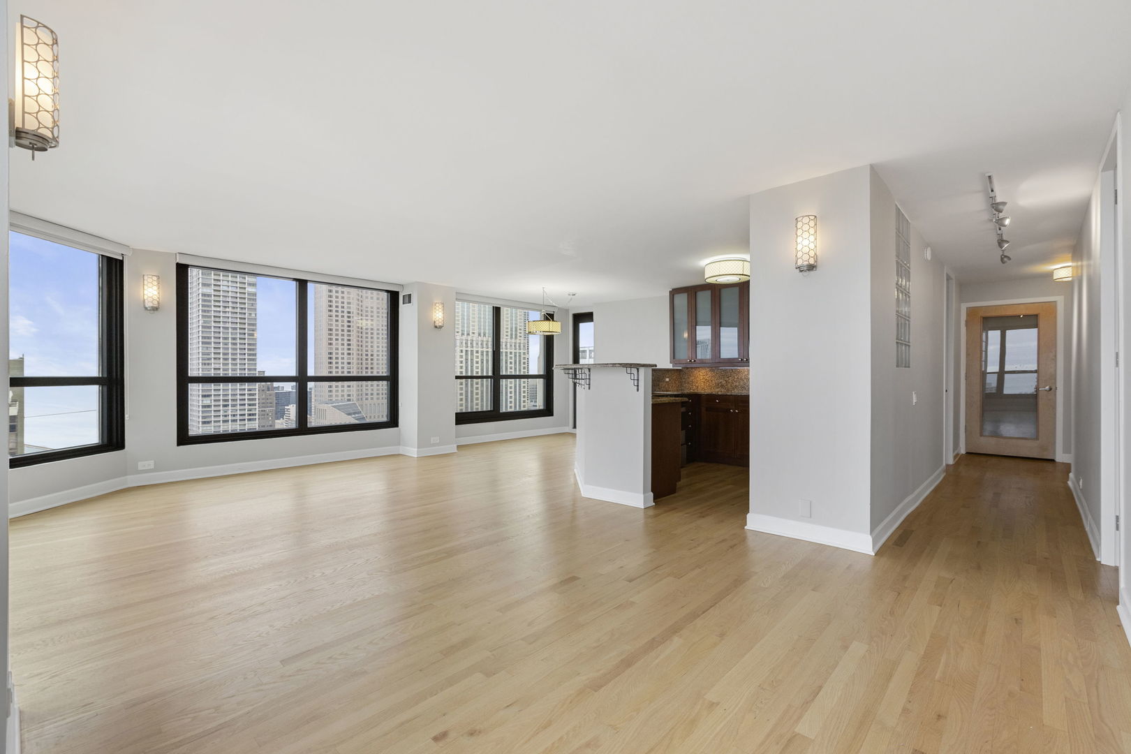 1030 North State Street, Unit 31E Chicago, IL 60610 - Photo 3 of 19 a view of a big room with wooden floor and windows