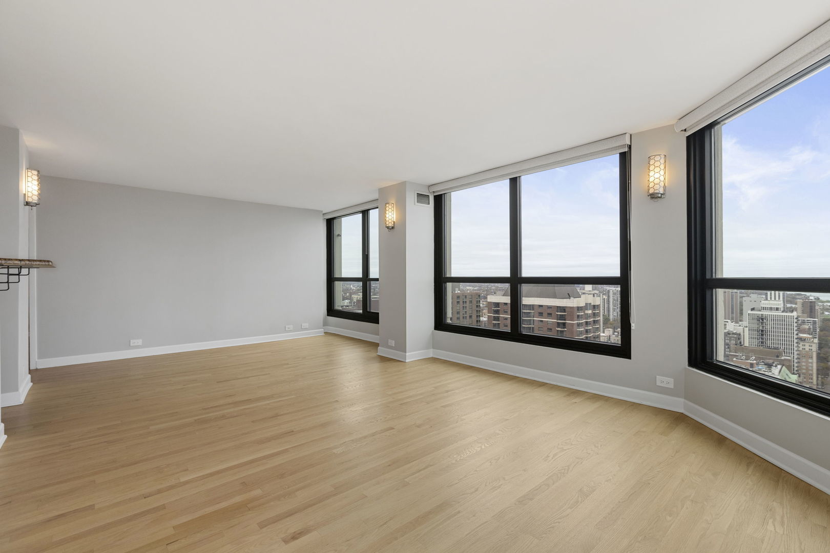 1030 North State Street, Unit 31E Chicago, IL 60610 - Photo 4 of 19 wooden floor in an empty room with a window