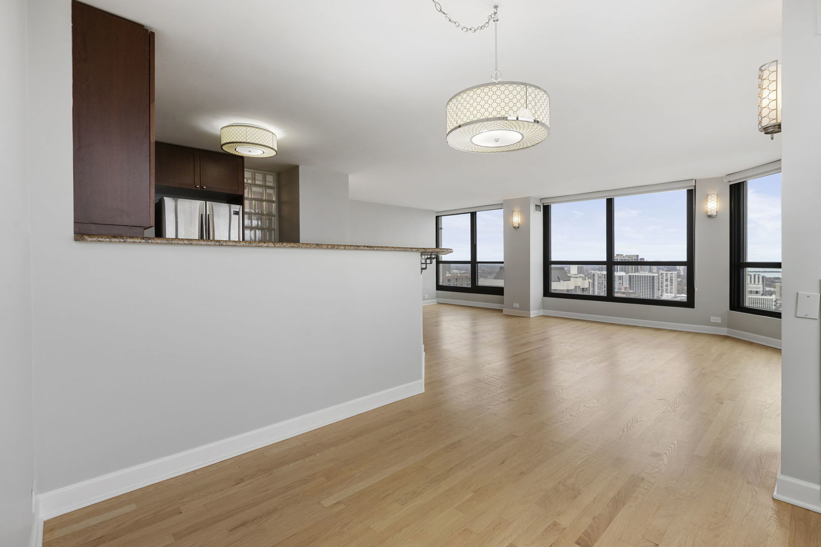 1030 North State Street, Unit 31E Chicago, IL 60610 - Photo 5 of 19 an empty room with wooden floor and windows
